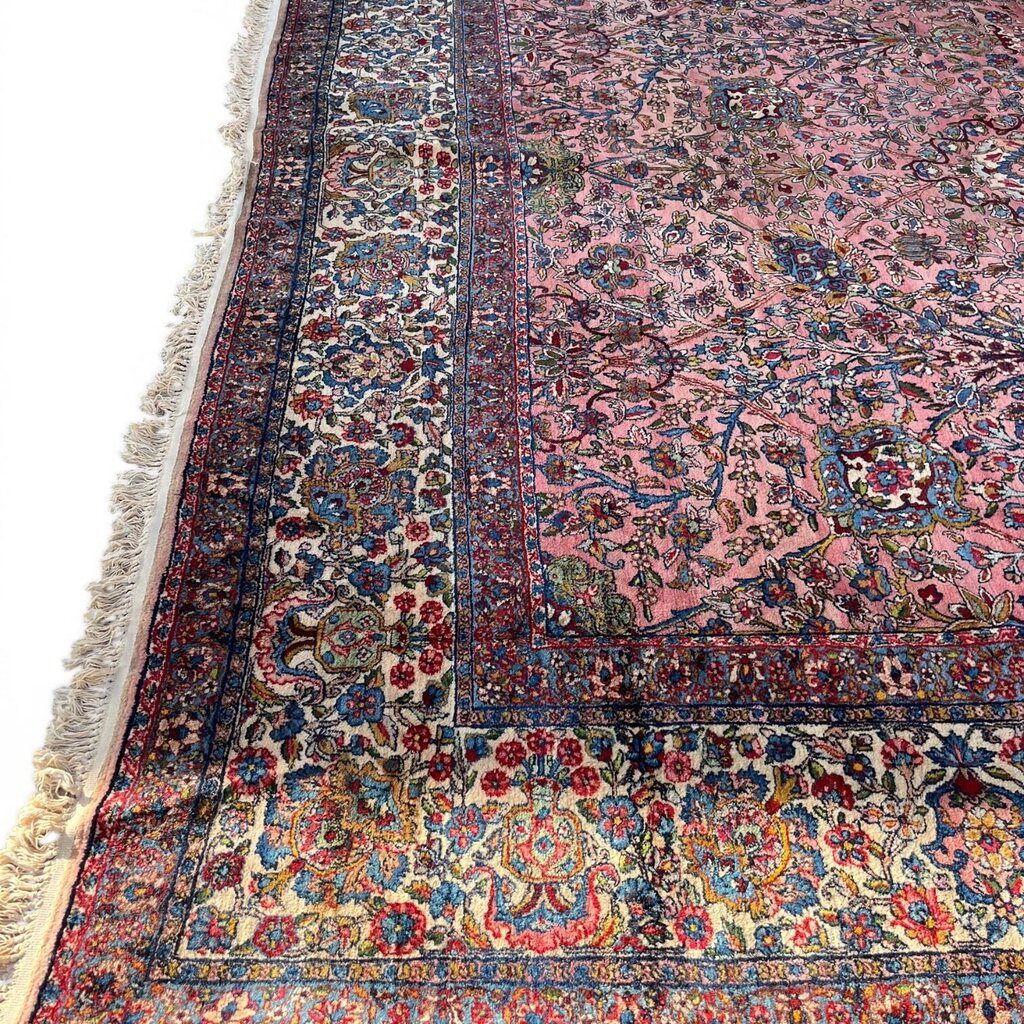 Early 20th Century Kerman Lavar Persian Rug, Hand-Knotted in Iran. Rose Field w/ Ivory Border Accented in Blue and Green. Fine Wool Pile on Cotton Foundation. Classic Overscale Room Size. Measures 11.06Lx19.01W. Circa 1920s.