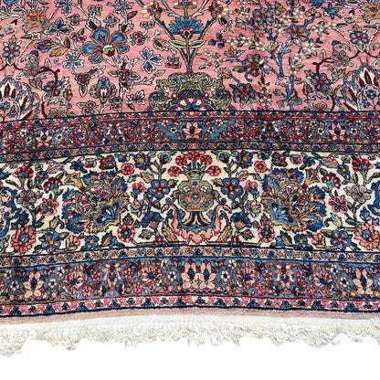 Early 20th Century Kerman Lavar Persian Rug, Hand-Knotted in Iran. Rose Field w/ Ivory Border Accented in Blue and Green. Fine Wool Pile on Cotton Foundation. Classic Overscale Room Size. Measures 11.06Lx19.01W. Circa 1920s.
