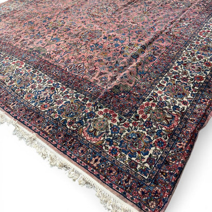 Early 20th Century Kerman Lavar Persian Rug, Hand-Knotted in Iran. Rose Field w/ Ivory Border Accented in Blue and Green. Fine Wool Pile on Cotton Foundation. Classic Overscale Room Size. Measures 11.06Lx19.01W. Circa 1920s.