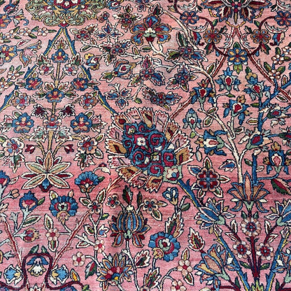 Early 20th Century Kerman Lavar Persian Rug, Hand-Knotted in Iran. Rose Field w/ Ivory Border Accented in Blue and Green. Fine Wool Pile on Cotton Foundation. Classic Overscale Room Size. Measures 11.06Lx19.01W. Circa 1920s.