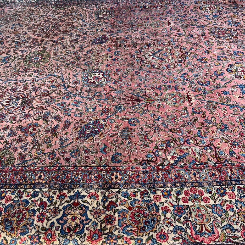 Early 20th Century Kerman Lavar Persian Rug, Hand-Knotted in Iran. Rose Field w/ Ivory Border Accented in Blue and Green. Fine Wool Pile on Cotton Foundation. Classic Overscale Room Size. Measures 11.06Lx19.01W. Circa 1920s.