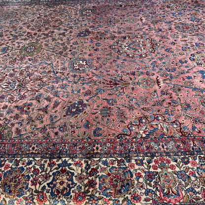 Early 20th Century Kerman Lavar Persian Rug, Hand-Knotted in Iran. Rose Field w/ Ivory Border Accented in Blue and Green. Fine Wool Pile on Cotton Foundation. Classic Overscale Room Size. Measures 11.06Lx19.01W. Circa 1920s.