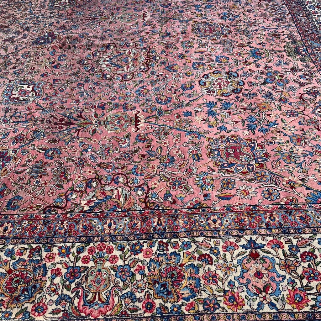 Early 20th Century Kerman Lavar Persian Rug, Hand-Knotted in Iran. Rose Field w/ Ivory Border Accented in Blue and Green. Fine Wool Pile on Cotton Foundation. Classic Overscale Room Size. Measures 11.06Lx19.01W. Circa 1920s.