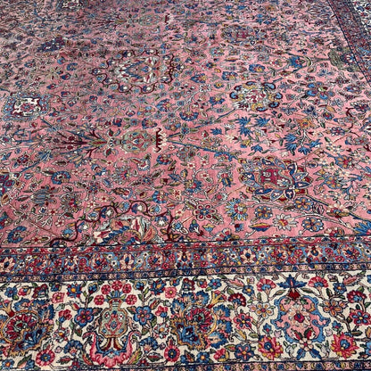 Early 20th Century Kerman Lavar Persian Rug, Hand-Knotted in Iran. Rose Field w/ Ivory Border Accented in Blue and Green. Fine Wool Pile on Cotton Foundation. Classic Overscale Room Size. Measures 11.06Lx19.01W. Circa 1920s.