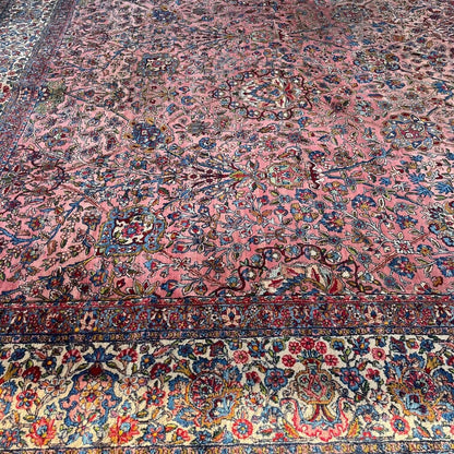 Early 20th Century Kerman Lavar Persian Rug, Hand-Knotted in Iran. Rose Field w/ Ivory Border Accented in Blue and Green. Fine Wool Pile on Cotton Foundation. Classic Overscale Room Size. Measures 11.06Lx19.01W. Circa 1920s.