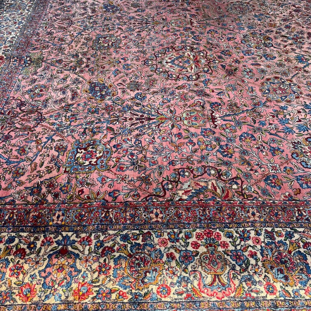 Early 20th Century Kerman Lavar Persian Rug, Hand-Knotted in Iran. Rose Field w/ Ivory Border Accented in Blue and Green. Fine Wool Pile on Cotton Foundation. Classic Overscale Room Size. Measures 11.06Lx19.01W. Circa 1920s.