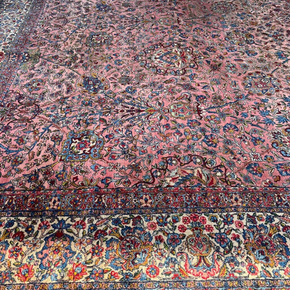 Early 20th Century Kerman Lavar Persian Rug, Hand-Knotted in Iran. Rose Field w/ Ivory Border Accented in Blue and Green. Fine Wool Pile on Cotton Foundation. Classic Overscale Room Size. Measures 11.06Lx19.01W. Circa 1920s.